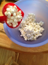 Add marshmallows to melted butter and melt in microwave for one minute.